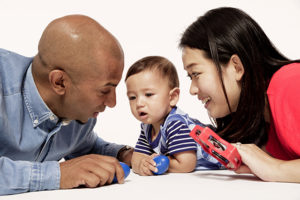 Mom and dad playing music instruments with an infant