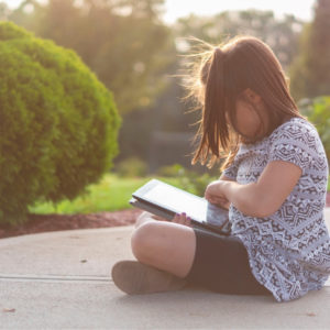 Girl sitting outside reading