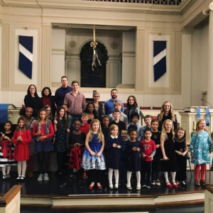 Large group of dressed up kids and adults in front of a buildings